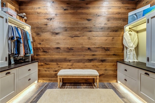 bathroom with wood walls and vanity