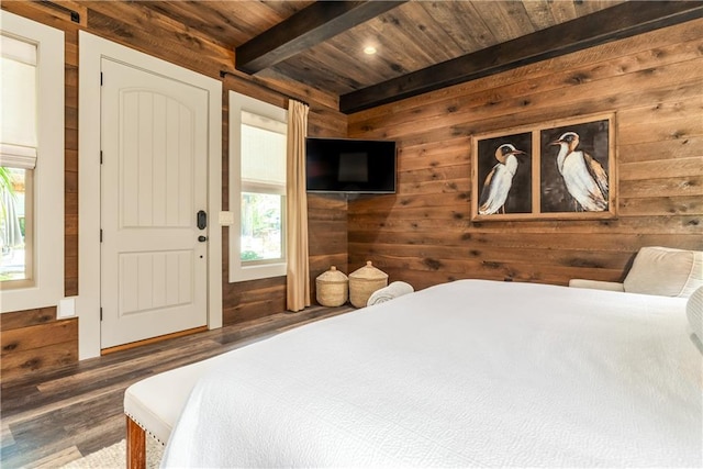 bedroom with wood ceiling, beamed ceiling, wood walls, and wood finished floors