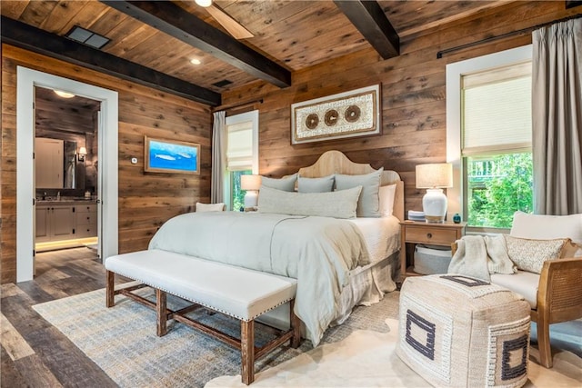 bedroom featuring wood walls, beamed ceiling, ensuite bathroom, wood ceiling, and hardwood / wood-style flooring