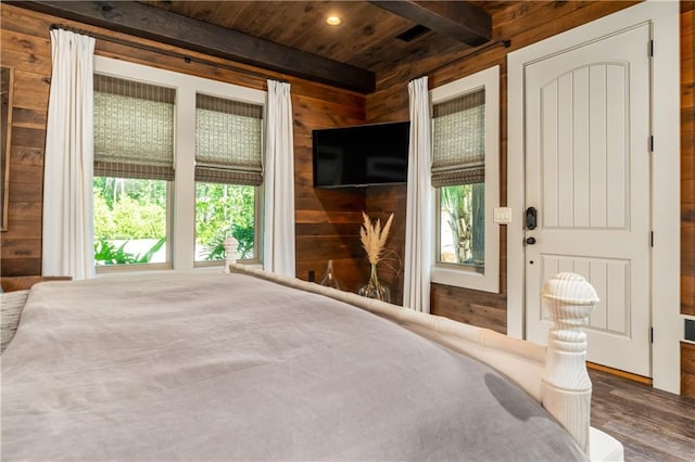 unfurnished bedroom with hardwood / wood-style flooring, wooden walls, beam ceiling, and wooden ceiling