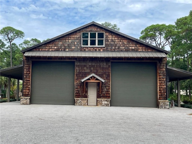 view of front of house with a garage and a carport