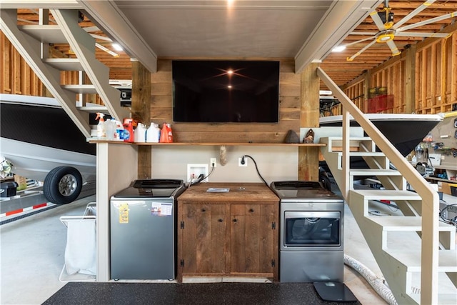 interior space featuring stainless steel refrigerator, concrete floors, and wood walls