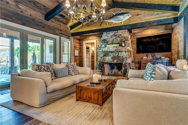 living room featuring a notable chandelier, a stone fireplace, wooden ceiling, lofted ceiling with beams, and hardwood / wood-style flooring