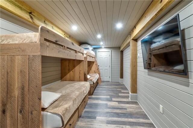 mudroom with hardwood / wood-style floors and wood walls