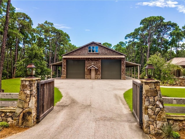 garage with aphalt driveway and a gate