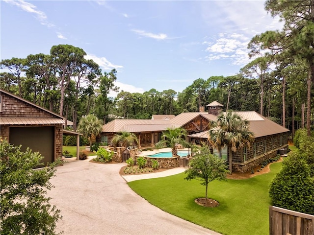 view of property's community with a swimming pool, a lawn, and a patio