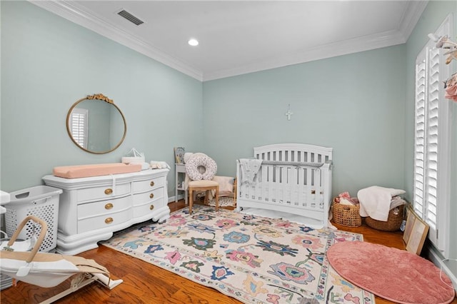 6905 Providence Estates Dr N, Mobile, AL 36695 - bedroom featuring wood finished floors, ornamental molding, a nursery area, and recessed lighting