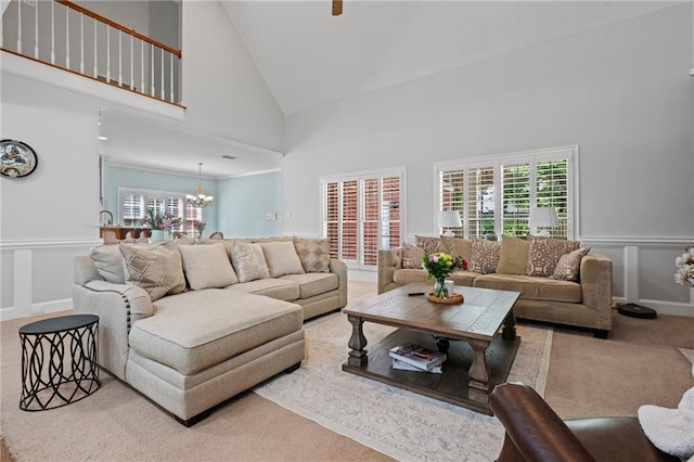 6905 Providence Estates Dr N, Mobile, AL 36695 - living room featuring high vaulted ceiling, carpet flooring, a chandelier, a wainscoted wall, and healthy amount of natural light