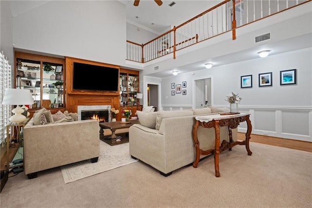6905 Providence Estates Dr N, Mobile, AL 36695 - living room with high vaulted ceiling, a premium fireplace, a ceiling fan, carpet flooring, and crown molding