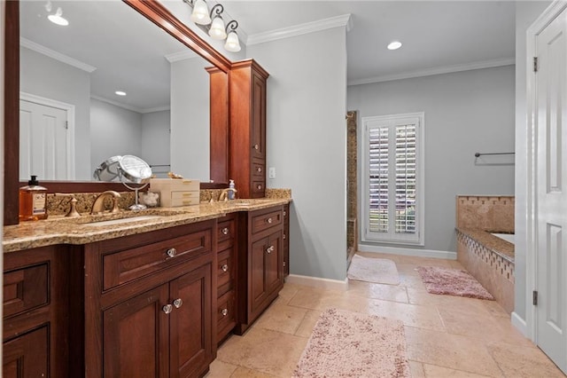 6905 Providence Estates Dr N, Mobile, AL 36695 - bathroom featuring stone tile floors, double vanity, a bath, ornamental molding, and recessed lighting