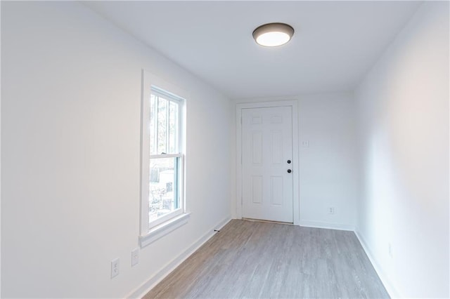 empty room with light hardwood / wood-style flooring