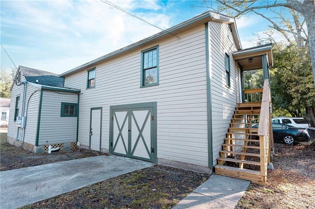 back of property with a garage