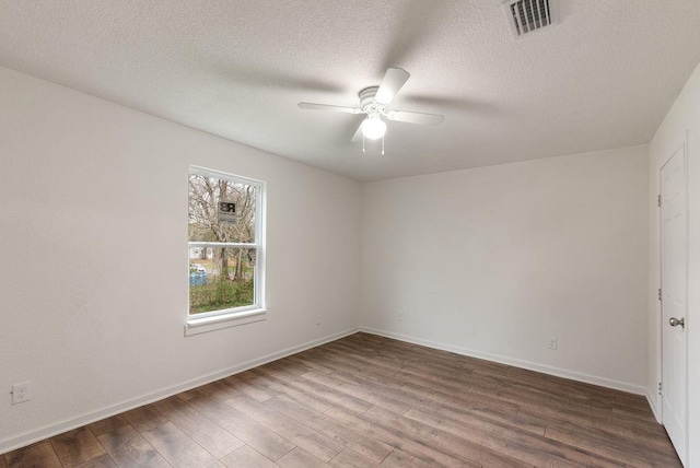 spare room featuring hardwood / wood-style flooring, a textured ceiling, and ceiling fan