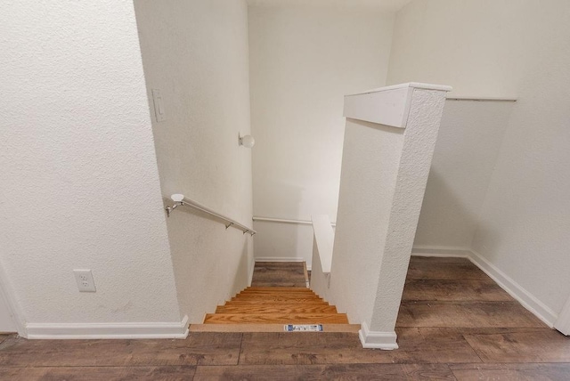 staircase with wood-type flooring