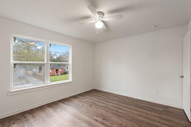 unfurnished room with ceiling fan, a textured ceiling, and dark hardwood / wood-style flooring