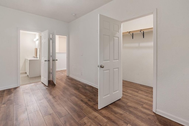 unfurnished bedroom featuring dark hardwood / wood-style floors and a closet