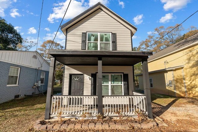 view of property featuring covered porch