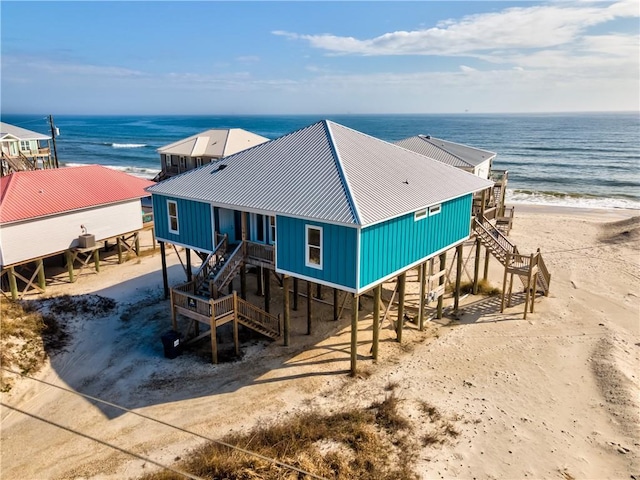 exterior space featuring a water view and a view of the beach