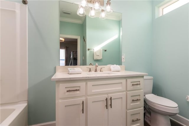 bathroom with toilet, vanity, visible vents, baseboards, and ornamental molding