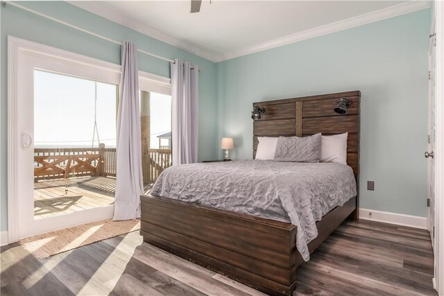 bedroom featuring dark wood-type flooring, a ceiling fan, baseboards, access to outside, and crown molding