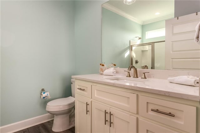 full bathroom with crown molding, toilet, vanity, wood finished floors, and baseboards