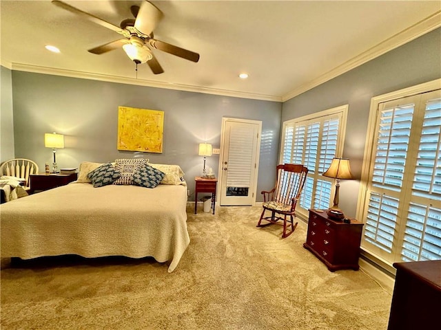 carpeted bedroom featuring ceiling fan and ornamental molding