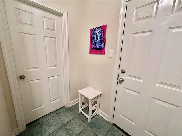 doorway to outside featuring tile patterned flooring