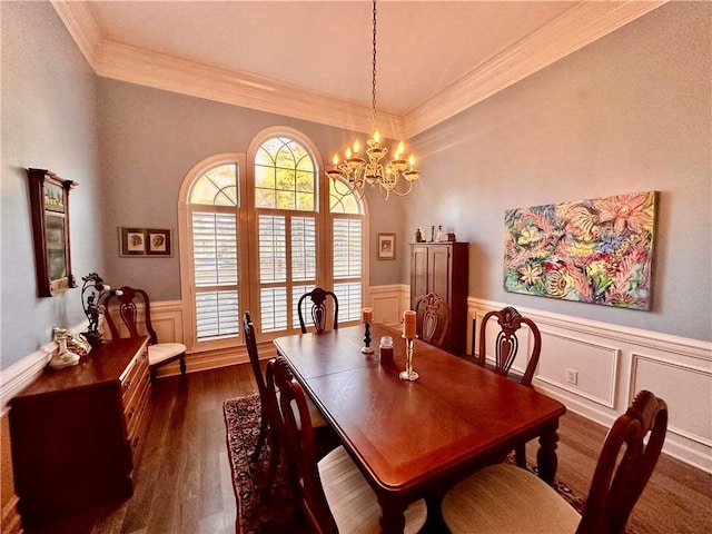 dining space featuring dark hardwood / wood-style flooring, ornamental molding, and a notable chandelier