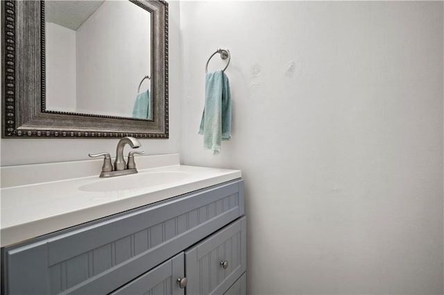 bathroom with a textured ceiling and vanity