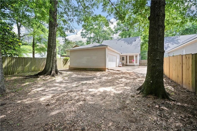 rear view of property with a fenced backyard