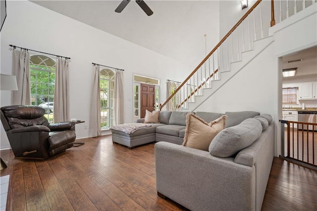 living room featuring stairway, a ceiling fan, high vaulted ceiling, and dark wood finished floors