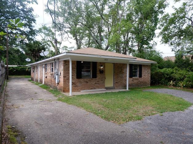 bungalow-style house with brick siding and aphalt driveway