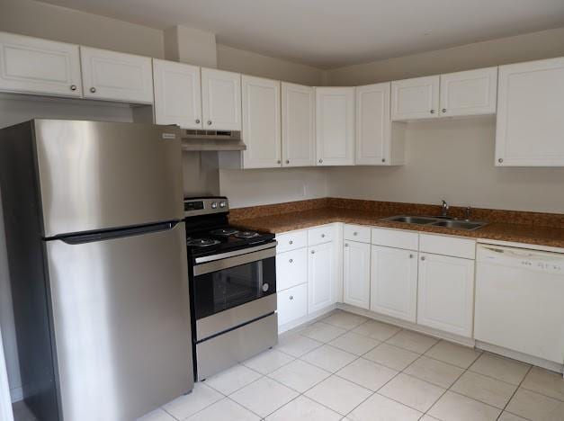 kitchen with under cabinet range hood, stainless steel appliances, white cabinets, and a sink