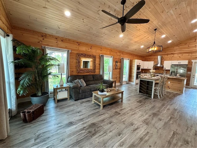 1401 Osprey Ln, Dauphin Island, AL 36528 - living room featuring wood finished floors, lofted ceiling, ceiling fan, wooden walls, and wooden ceiling