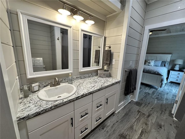 1401 Osprey Ln, Dauphin Island, AL 36528 - bathroom featuring wood walls, wood finished floors, and vanity