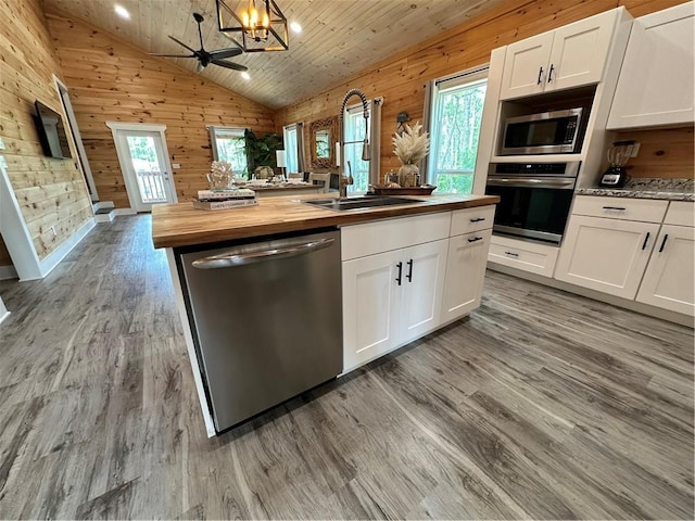 1401 Osprey Ln, Dauphin Island, AL 36528 - kitchen with a healthy amount of sunlight, appliances with stainless steel finishes, butcher block countertops, and a sink