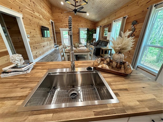 1401 Osprey Ln, Dauphin Island, AL 36528 - kitchen featuring wood walls, wooden counters, open floor plan, wood finished floors, and vaulted ceiling