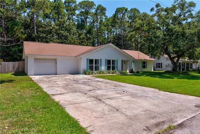 ranch-style home featuring a garage and a front lawn