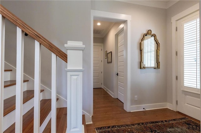 entryway featuring wood finished floors, baseboards, stairway, ornamental molding, and recessed lighting
