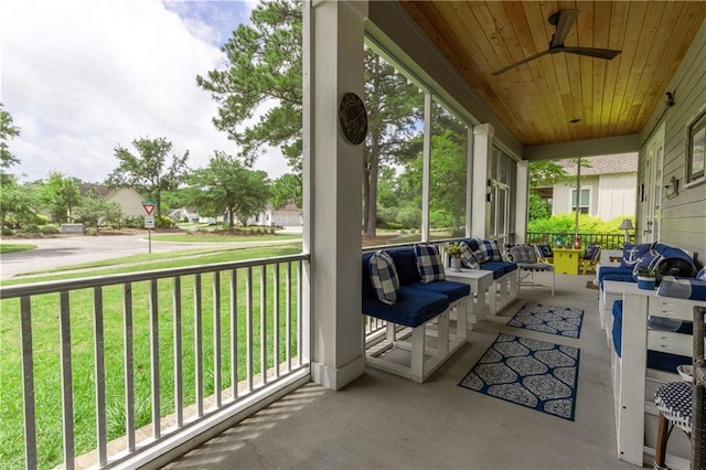sunroom featuring ceiling fan, healthy amount of natural light, and outdoor lounge area