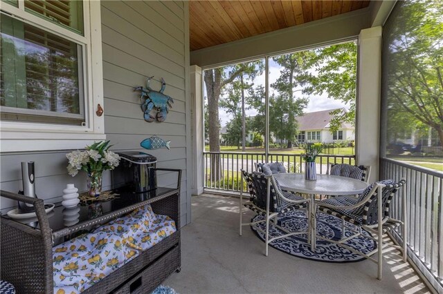 sunroom featuring outdoor dining space
