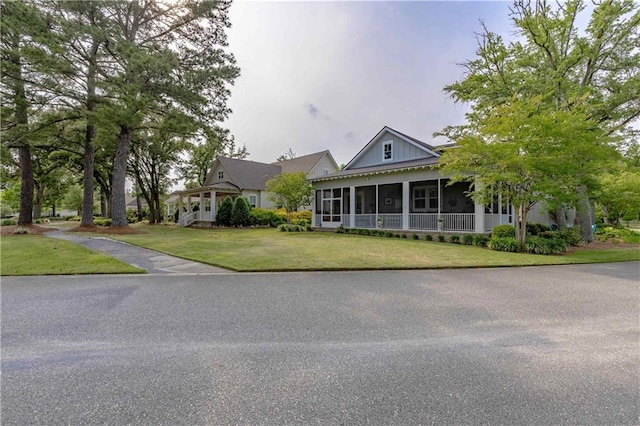 556 Artesian Spring Dr, Fairhope, AL 36532 - farmhouse-style home featuring a sunroom and a front yard