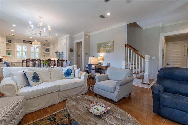 living room with a chandelier, ornamental molding, stairway, wood finished floors, and recessed lighting