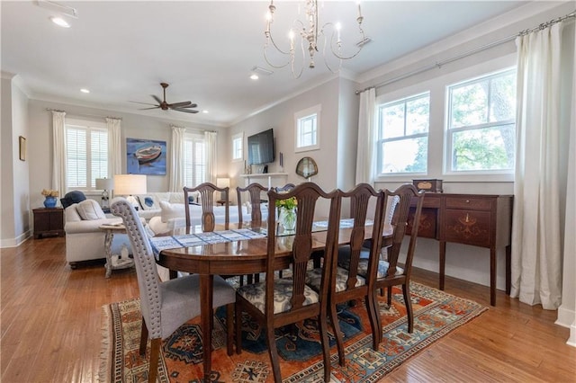 dining area featuring ornamental molding, plenty of natural light, light wood-style flooring, recessed lighting, and a chandelier