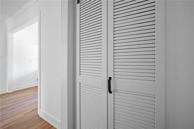 interior details with ornamental molding and hardwood / wood-style floors