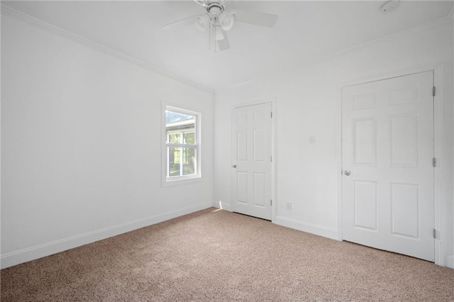 unfurnished bedroom with ornamental molding, carpet, and ceiling fan