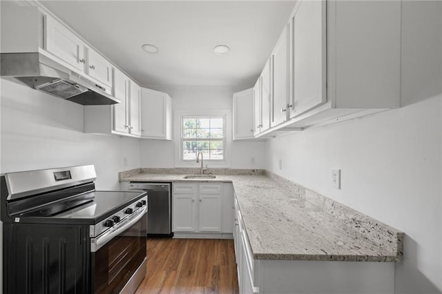 kitchen with appliances with stainless steel finishes, white cabinets, light stone countertops, dark hardwood / wood-style floors, and sink