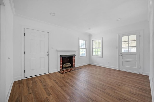 unfurnished living room with hardwood / wood-style flooring, a fireplace, and a healthy amount of sunlight