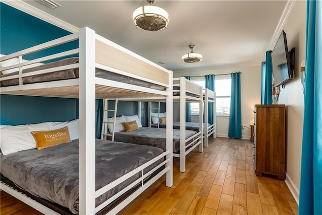 bedroom with baseboards and wood finished floors