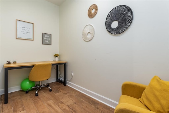 home office featuring baseboards and wood finished floors